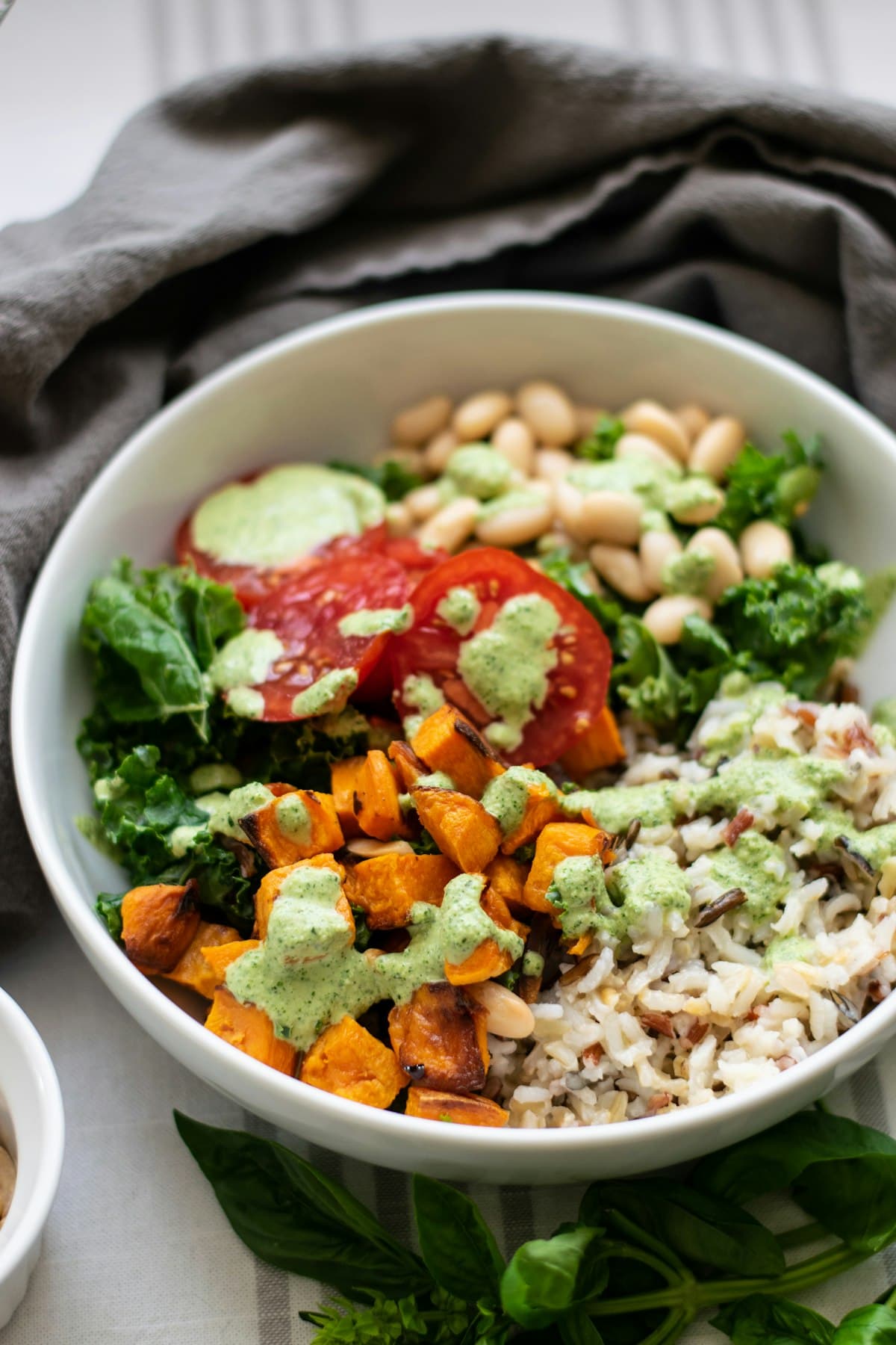 Colorful balanced bowl with rice, vegetables, and fresh herbs