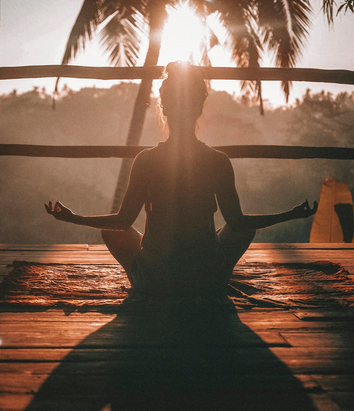Silhouette meditating at golden hour, a moment of calm focus